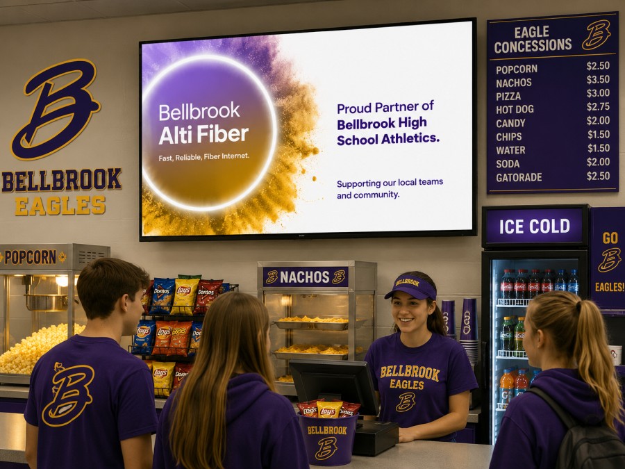 Digital menu and concession signage above a busy concession counter